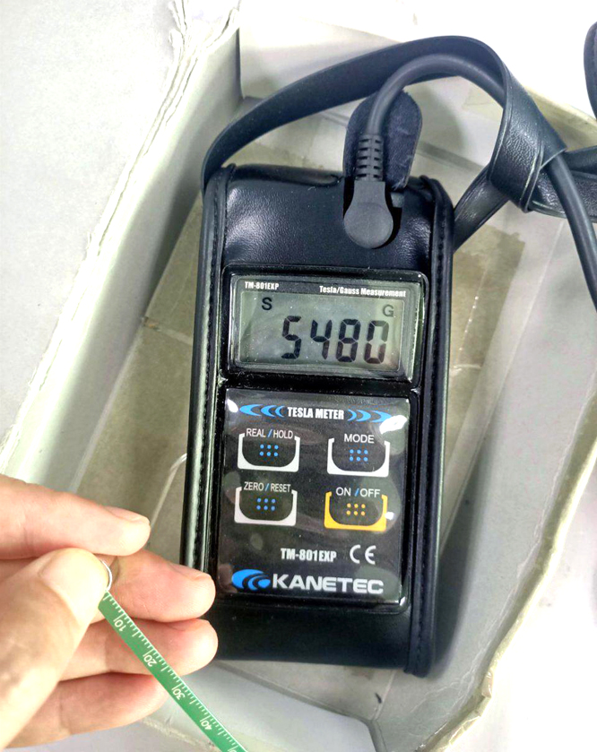 What is the magnetic induction strength of a neodymium magnet in T?